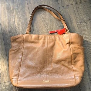 Spacious tan tote by Coach.